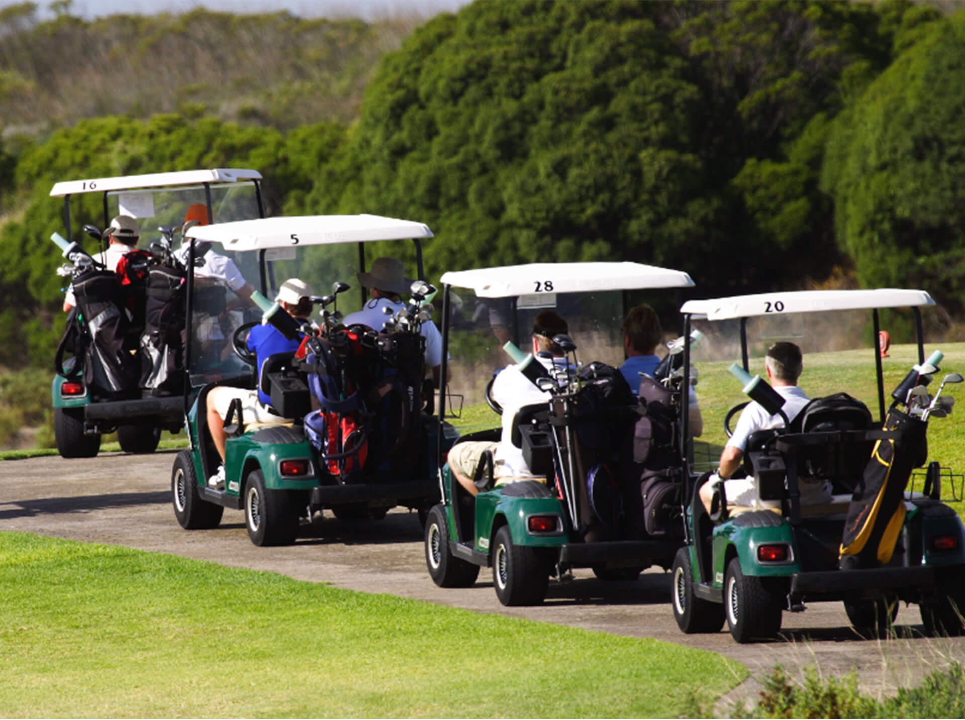 A group of golf carts parked at the westside golf club, supported by the Guildford Hotel.