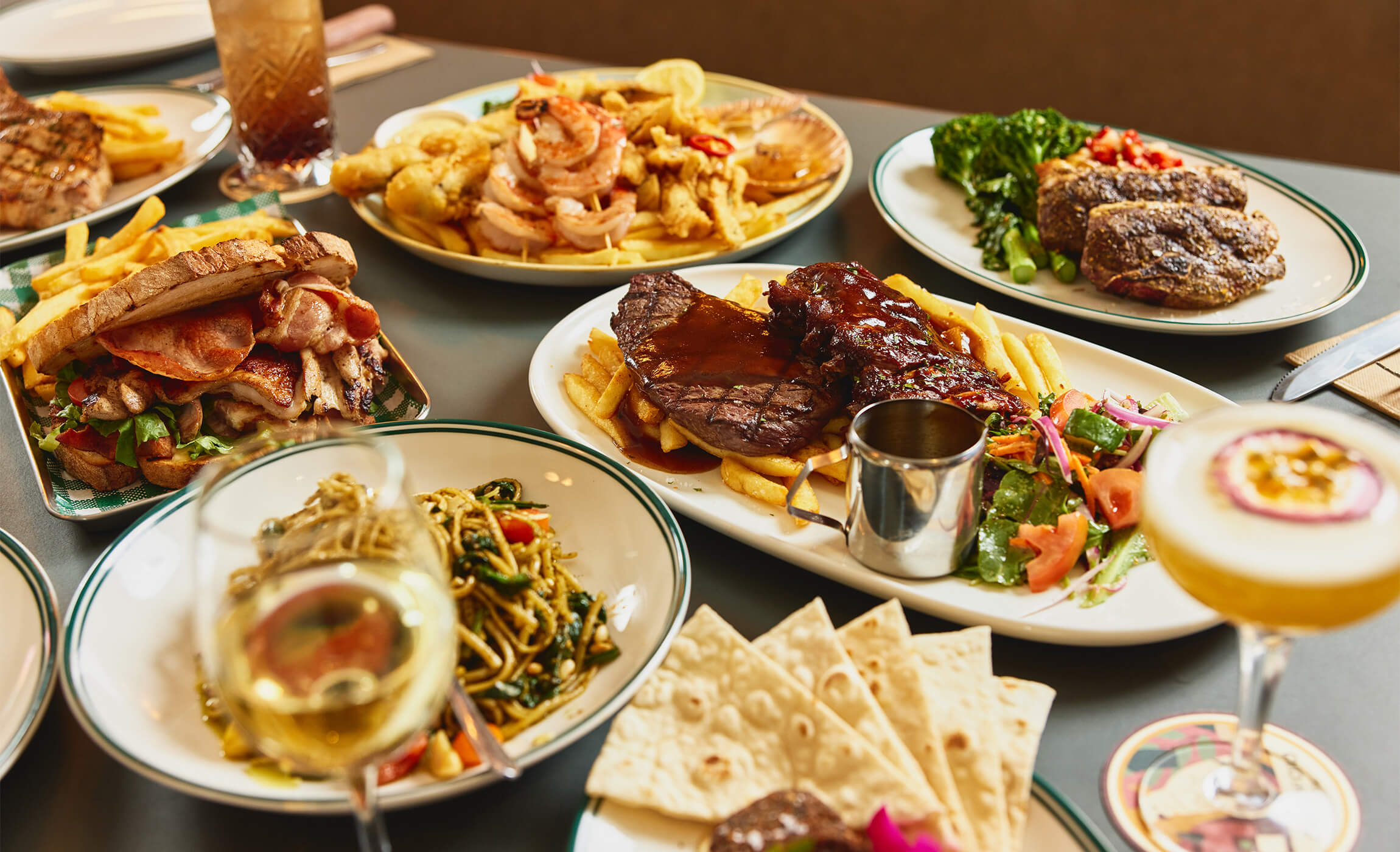 a selection of main meals including steak, a seafood platter and linguini